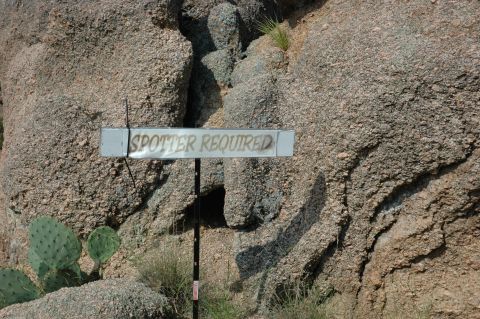 2001 Jeep Wrangler - A sign in a rocky desert area warns that a spotter is required, with prickly pear cactus visible.