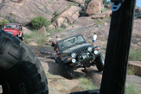 2001 Jeep Wrangler - Multiple Jeeps navigate a rocky terrain, off-road capabilities.