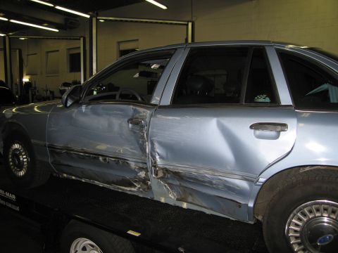 1991 Ford LTD Crown Victoria - This 1991 Ford Crown Victoria LTD shows significant damage to its driver's side door and rear quarter panel.