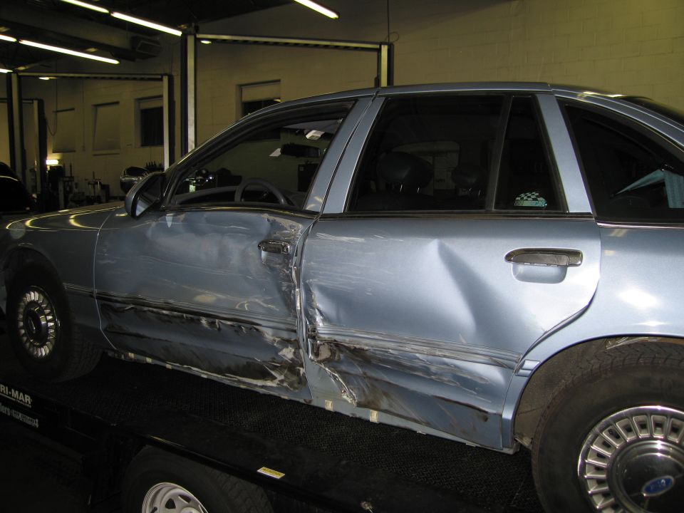 Side view of a damaged 1991 Ford Crown Victoria LTD