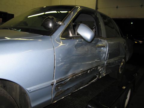 1991 Ford LTD Crown Victoria - Driver's side of a 1991 Ford Crown Victoria LTD shows extensive damage from an accident.