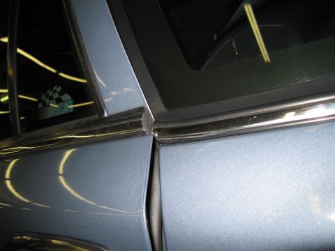 1991 Ford LTD Crown Victoria - Close-up of a car's door seam, showing metallic paint and trim detail trim.