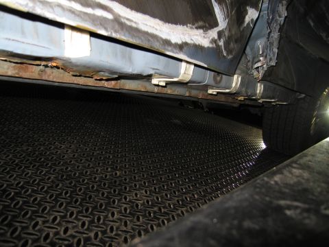 1991 Ford LTD Crown Victoria - This photo shows the heavily rusted rocker panel of a vehicle, with visible damage and some repair attempts.
