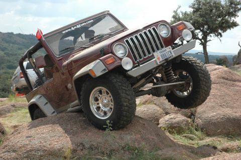 2001 Jeep Wrangler - A Jeep Wrangler navigates a rocky terrain, its off-road capabilities.