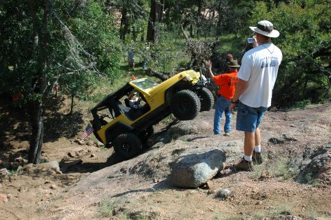 2001 Jeep Wrangler - A yellow 2001 Jeep Wrangler navigates a challenging off-road course.