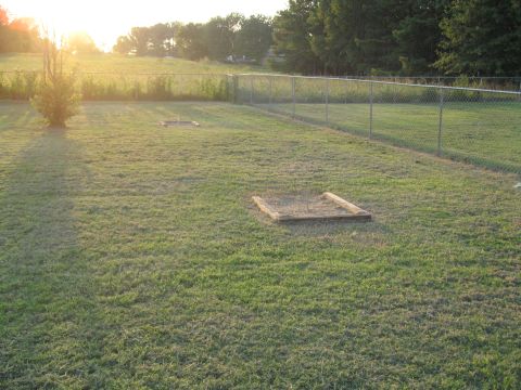 1988 Ford Bronco - Backyard scene with horseshoe pits and a fence during sunset.