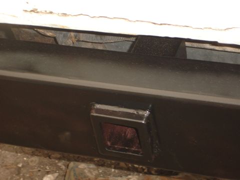1989 Ford Bronco - Close-up of a vehicle's rear bumper, showing a red reflector insert.