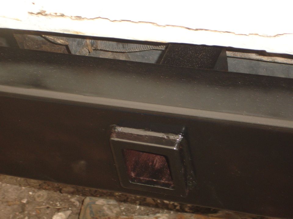 Rear bumper section with a red reflector insert