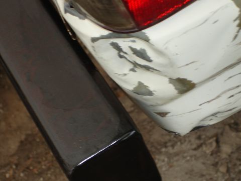 1989 Ford Bronco - The rear bumper shows significant damage and paint scuffing.