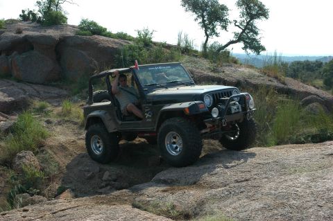 2001 Jeep Wrangler - Driver navigates a 2001 Jeep Wrangler over a rocky obstacle course.