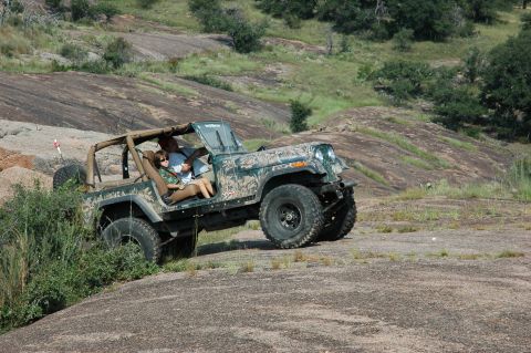 2001 Jeep Wrangler - Jeep Wrangler navigates a rocky landscape, showing its off-road capabilities.