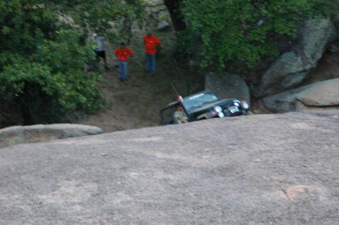 2001 Jeep Wrangler - Jeep Wrangler navigating difficult rocky terrain with onlookers present.