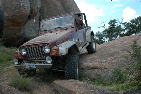 2001 Jeep Wrangler - This 2001 Jeep Wrangler navigates a rocky terrain, displaying a "www.4x4fun.com" sticker on its windshield.