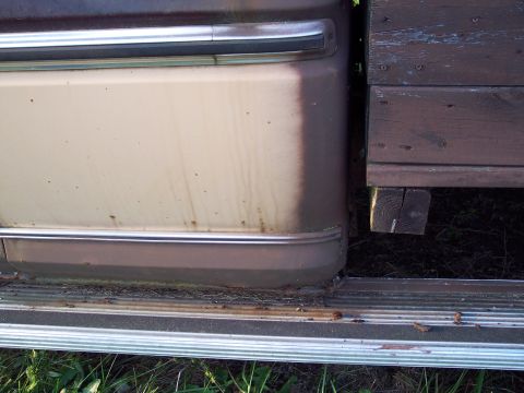 1978 Ford F-250 - Close-up of the side of a 1978 Ford F-250, showing the door and running board with visible wear and tear.