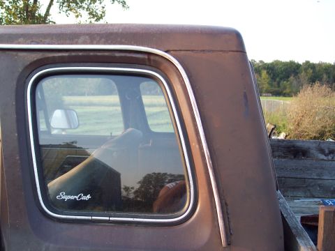 1978 Ford F-250 - Close-up of the rear side window and trim on a 1978 Ford F-250 SuperCab truck.
