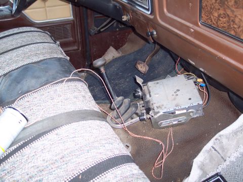 1978 Ford F-250 - The interior of a vehicle displays a floor-mounted shifter and an aftermarket radio unit.
