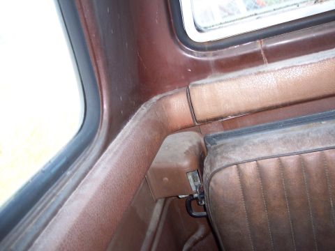 1978 Ford F-250 - The interior of the truck shows worn brown upholstery and trim panels.