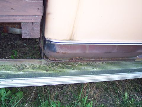 1978 Ford F-250 - Close-up of a truck's lower body panel showing rust and trim detail.