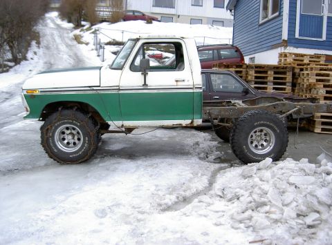 1979 Ford F-150 - A 1979 Ford F-150 truck cab is attached to a bare chassis, with snow and ice on the ground.