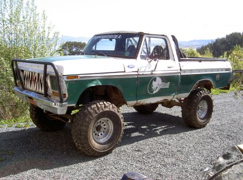 1979 Ford F-150 - This modified 1979 Ford F-150 pickup truck features a custom grille, lifted suspension, and off-road tires.