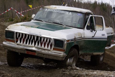 1979 Ford F-150 - This 1979 Ford F-150 features a custom shark teeth grille and appears to be stuck in mud during an off-road event.