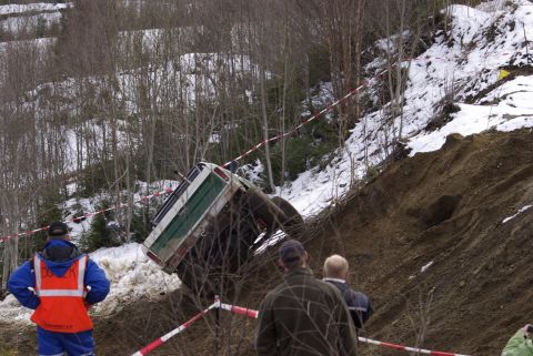 1979 Ford F-150 - An off-road vehicle is stuck on a steep, muddy incline during an event.