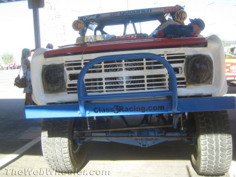 1990 Ford Bronco - Front of a white early Ford off-road race truck with a red roof, Ford and BFGoodrich graphics and a blue Class3Racing.com tube bumper.