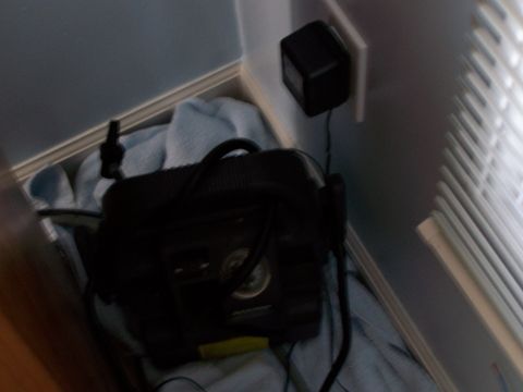 2003 Ford Crown Victoria - An air compressor and its power adapter are visible, plugged into a wall outlet.