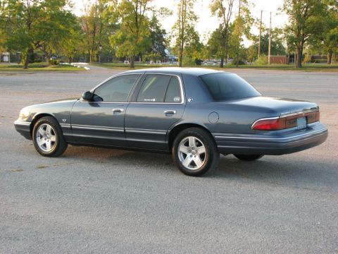 1985 Mercury Grand Marquis - A Mercury Grand Marquis is shown from the rear three-quarter view in an outdoor parking lot.