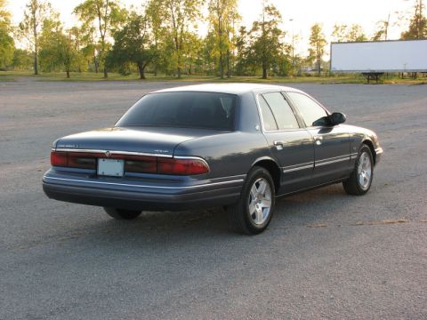 1985 Mercury Grand Marquis - Rear view of a Mercury Grand Marquis sedan parked outdoors during the day.