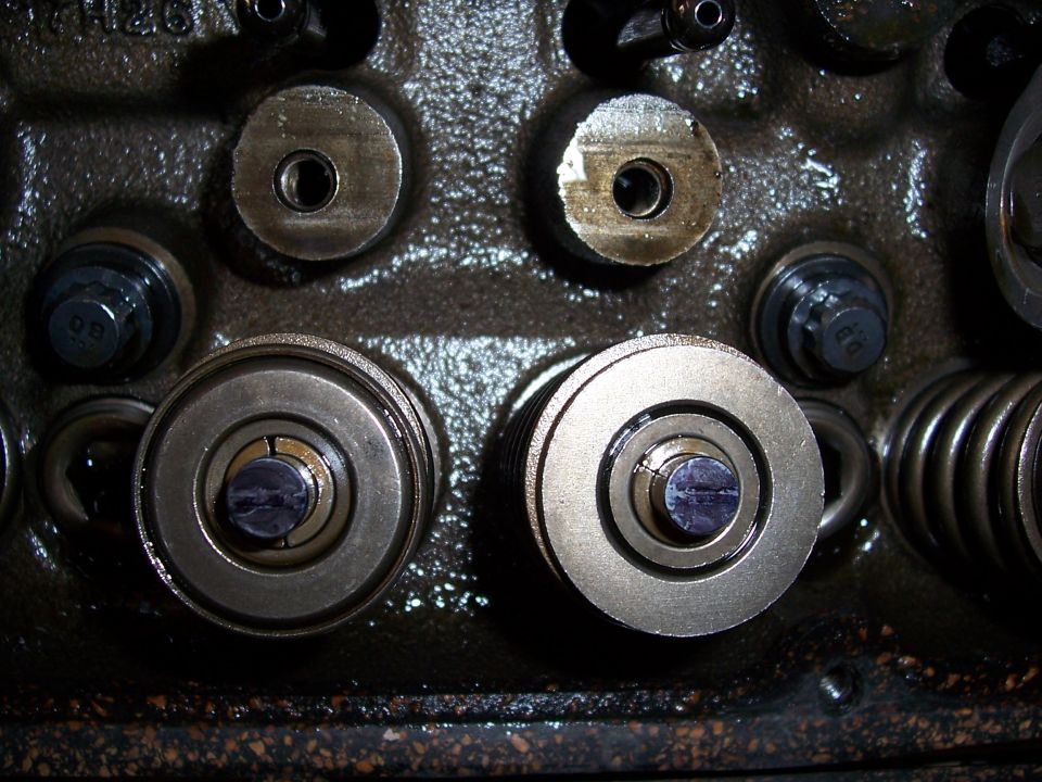Engine valve train components with visible springs and adjusters