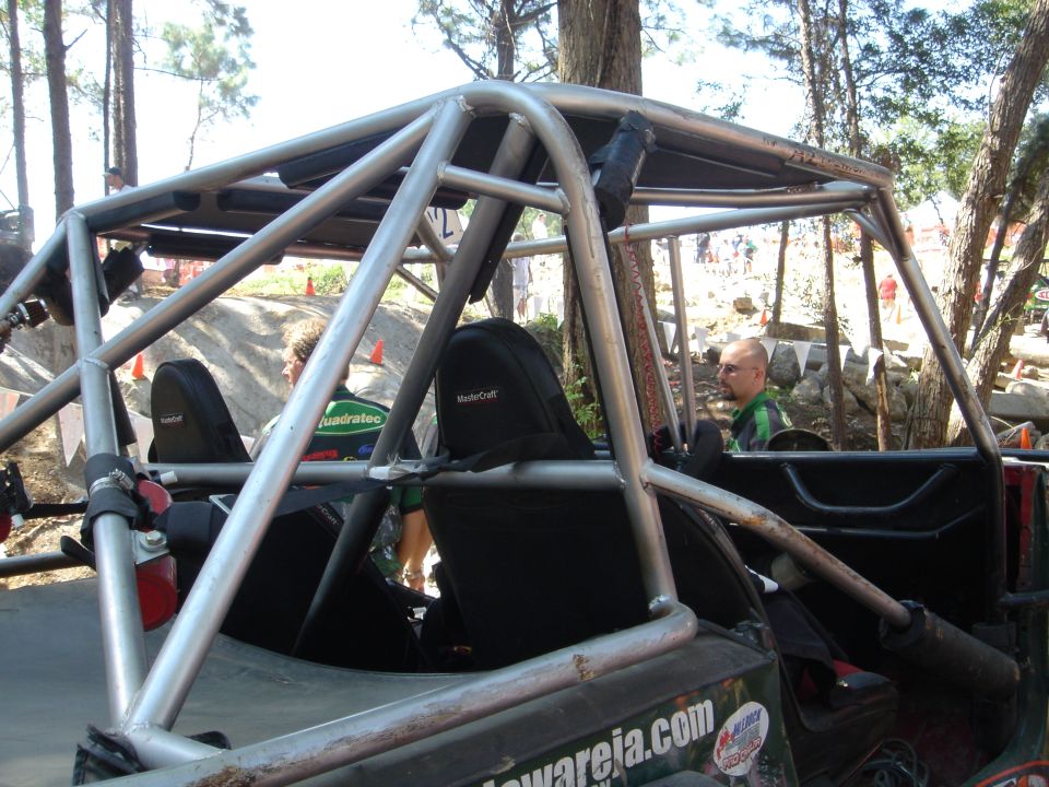 Rock buggy tube cage cockpit with black MasterCraft seats and fire extinguisher