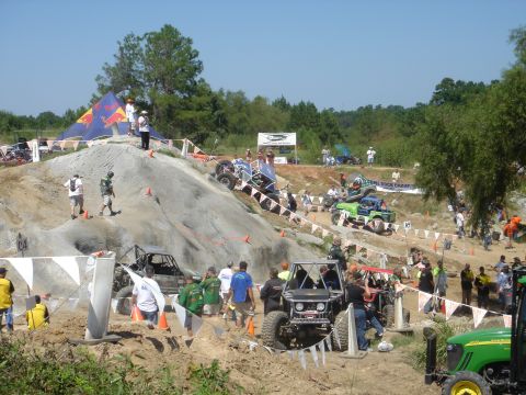 2002 Jeep Wrangler - Vehicles compete in an off-road crawling event with spectators watching from the sidelines.