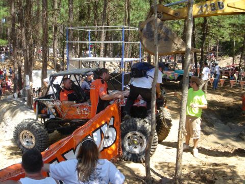 2002 Jeep Wrangler - Off-road buggy event with spectators and heavy machinery present.