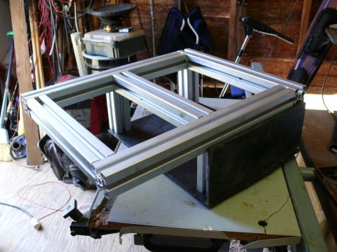 1988 Ford Bronco - An aluminum frame structure is shown on a workbench, with various tools and equipment in the background.
