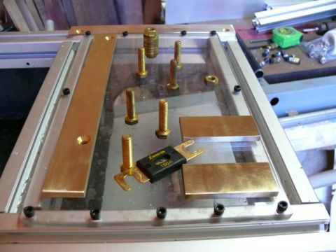 1988 Ford Bronco - A close-up view of a battery fuse and various bolts and brass plates, possibly for a custom installation.