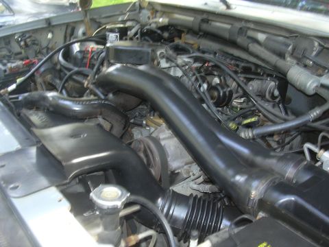 1997 Ford Crown Victoria - Close-up view of a vehicle's engine bay, showing various components and wiring.