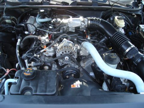 2000 Ford Crown Victoria - The engine compartment of a 2000 Ford Crown Victoria is shown, detailing various components.