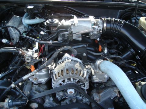 2000 Ford Crown Victoria - Close-up view of a vehicle's engine bay, showing complex mechanical components and wiring.