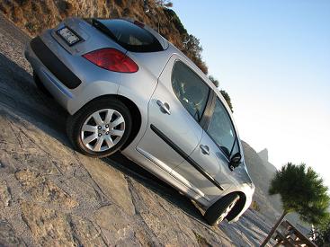 2003 Ford Crown Victoria - Silver hatchback parked on a rocky incline under a clear sky.