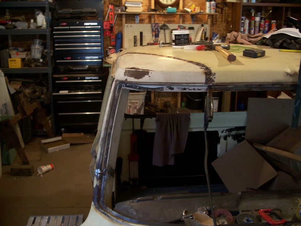 1979 Ford F-150 cab interior showing roofline and window frame, with tool chests in background