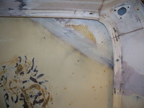1979 Ford F-150 - Close-up of a vehicle's interior body panel with visible rust and repair patches.