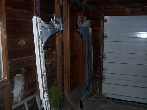 1979 Ford F-150 - Car body panels are suspended for work inside a garage, with a sectional garage door visible in the background.