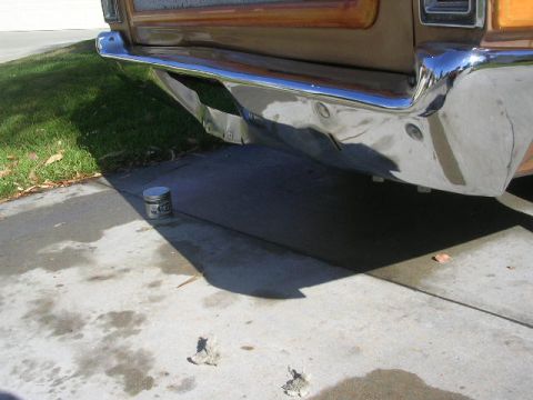 1975 Ford Ranchero - The rear of a 1975 Ford Ranchero shows a chrome bumper with some damage.