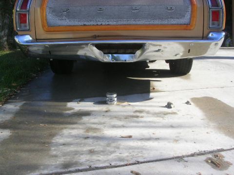 1975 Ford Ranchero - The rear of a 1975 Ford Ranchero shows its chrome bumper and wood-paneled tailgate.
