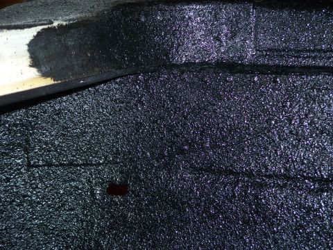 1979 Ford F-150 - The image shows a textured black undercoating applied to a vehicle's undercarriage or a similar part.
