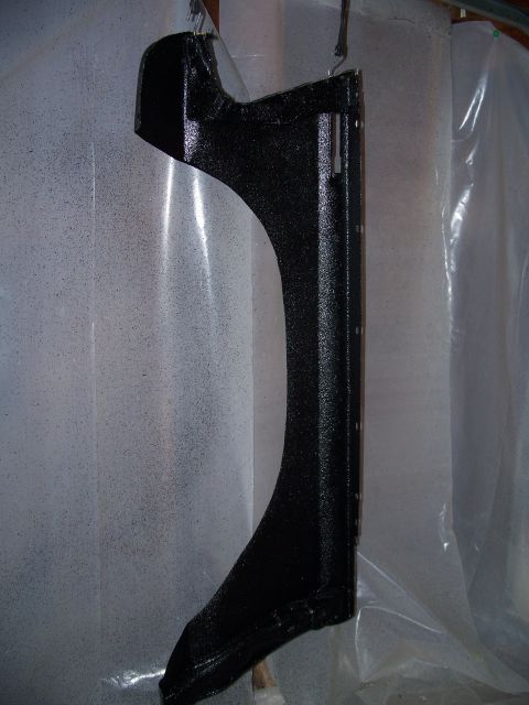 1979 Ford F-150 - A black painted fender section is being coated and appears to be hanging.