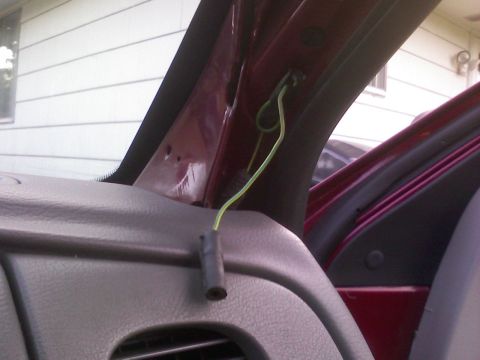 2001 Ford Crown Victoria - Exposed wiring and a connector are visible inside the car's A-pillar area.