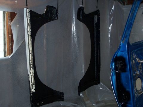 1979 Ford F-150 - Two car fenders are painted black, with a blue car door visible to the right.