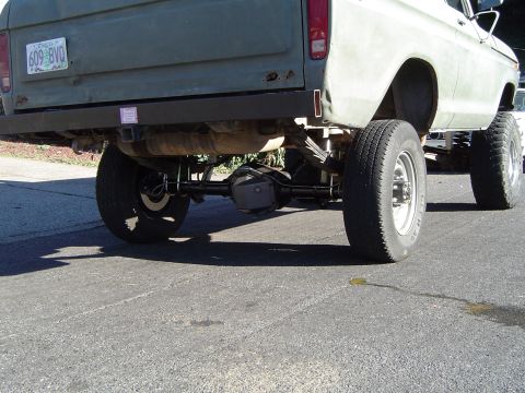 1978 Ford Bronco - The rear of a lifted truck is shown, with a focus on the suspension and axle components. A license plate is visible.